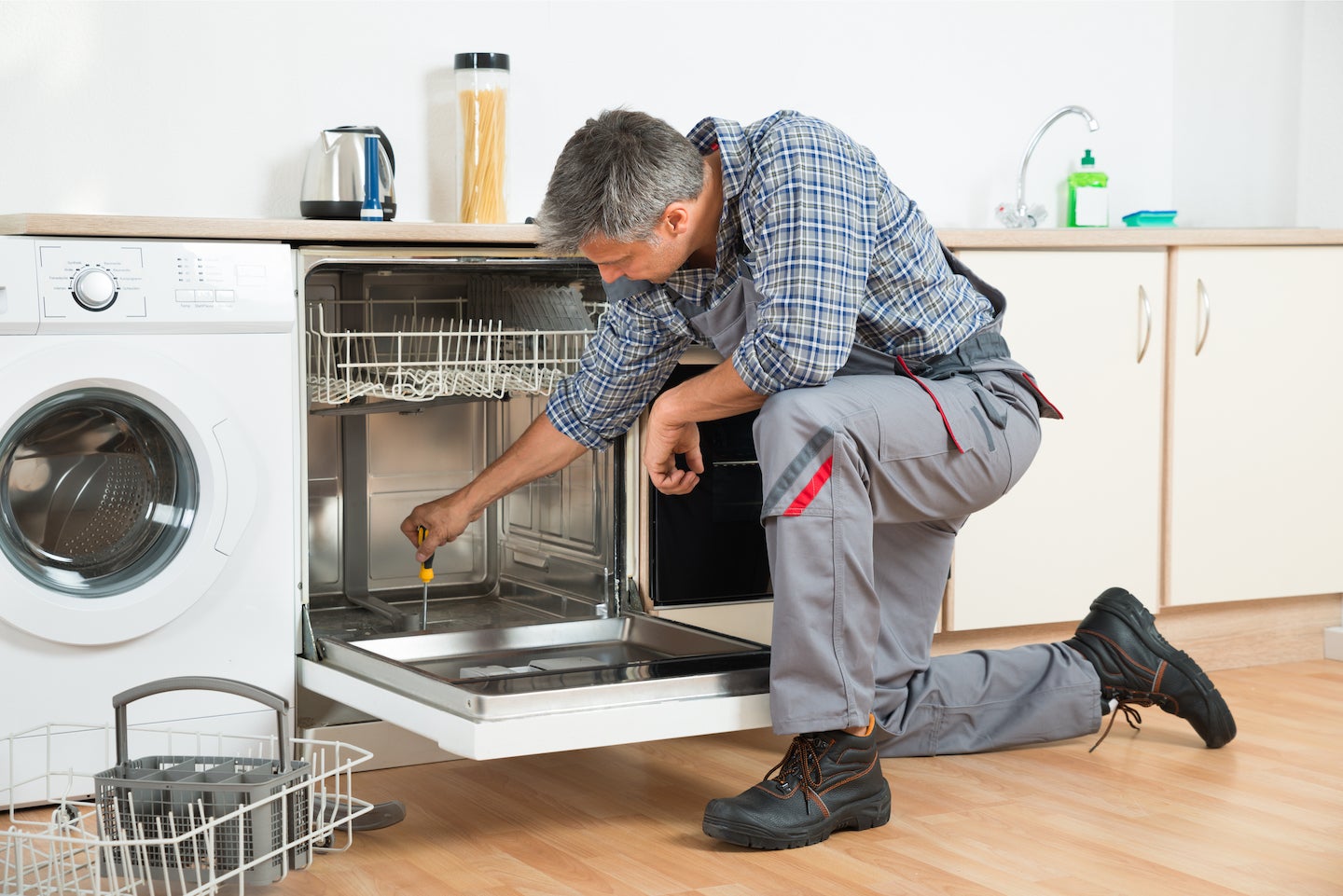 Repairman reviews dishwasher repairs with Los Angeles couple.