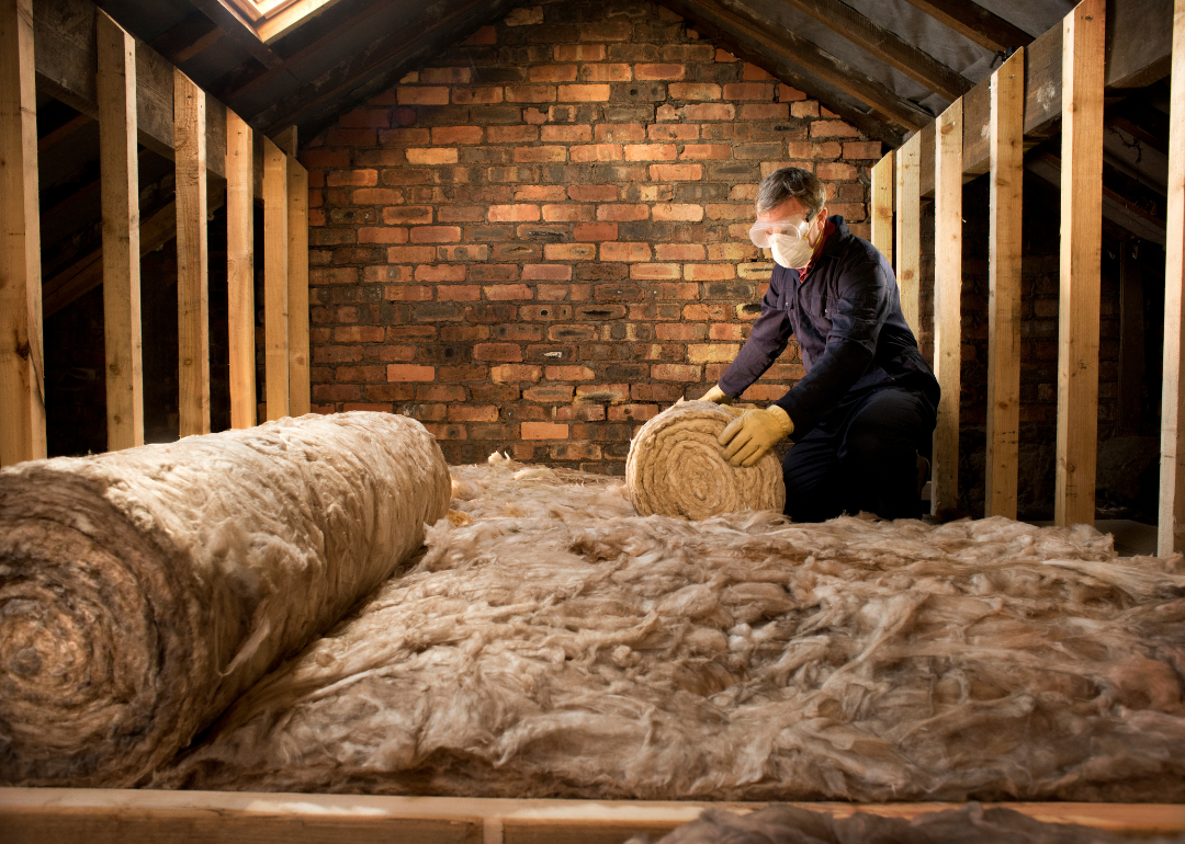 Man adds insulation to attic 