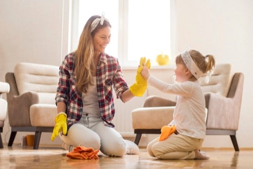 mother-wearing-yellow-rubber-cleaning-gloves-high-fiving-her-toddler-daughter.jpg